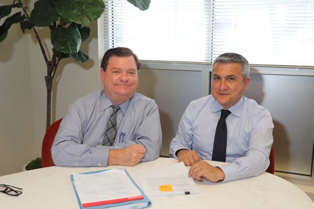 Picture of Volunteer Robert Unetic with CLS SoCal directing attorney Renato Izquieta sitting at a table.